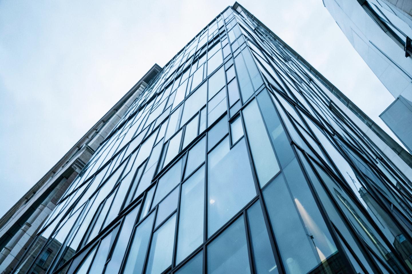 Glass and steel office facade seen from below