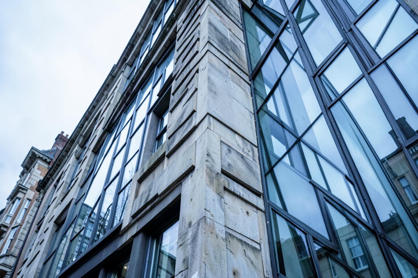 Stone and glass commercial building facade seen from below