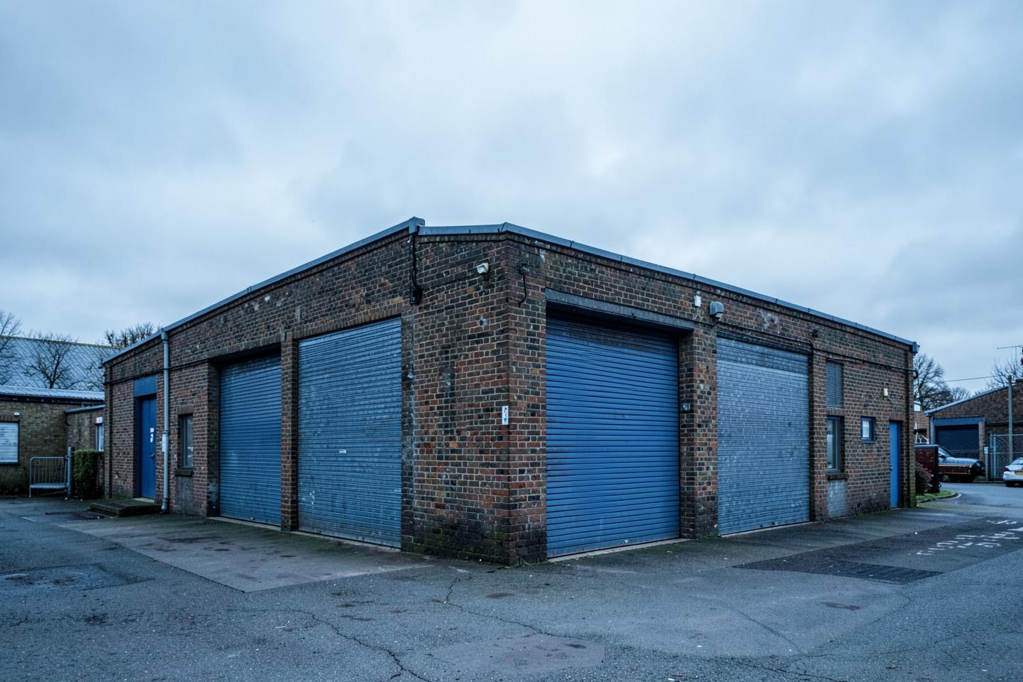 Exterior of a brick factory unit with roller shutter doors